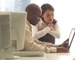 An SEO specialist working with a book author using a laptop computer.